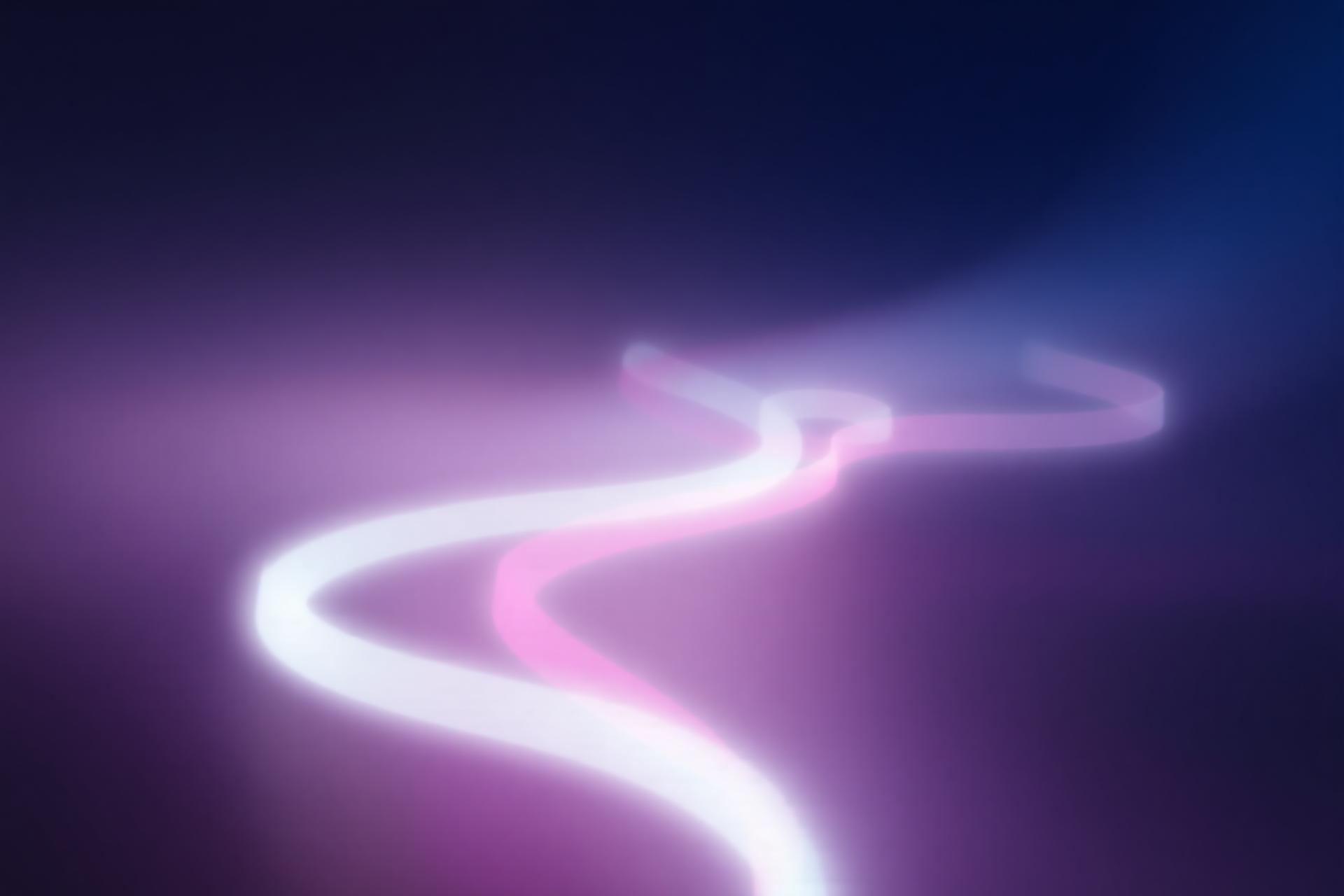 Pink light trails representing electronic music energy